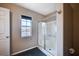 Modern bathroom featuring a glass-enclosed shower, tile flooring, and natural light at 11092 Abbeyfield Rose Dr, Henderson, NV 89052