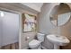 Half bathroom with pedestal sink and tiled floors at 11092 Abbeyfield Rose Dr, Henderson, NV 89052
