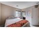 Bedroom with a window, patterned quilt, and mirrored closet at 11092 Abbeyfield Rose Dr, Henderson, NV 89052