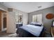Cozy bedroom features natural light from the window and a mirrored closet at 11092 Abbeyfield Rose Dr, Henderson, NV 89052