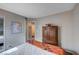 Bedroom with a large wood armoire and a doorway leading to another room at 11092 Abbeyfield Rose Dr, Henderson, NV 89052