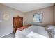 Bedroom featuring artwork, wood armoire, and a comfortable bed at 11092 Abbeyfield Rose Dr, Henderson, NV 89052
