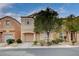 Charming two-story home with a well-maintained front yard, showcasing its inviting curb appeal and cozy residential setting at 11092 Abbeyfield Rose Dr, Henderson, NV 89052