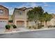 Charming two-story home with a well-manicured front yard and attached garage in a quiet neighborhood at 11092 Abbeyfield Rose Dr, Henderson, NV 89052