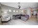 Spacious living room with contemporary furnishings, ceiling fan and ample lighting at 11092 Abbeyfield Rose Dr, Henderson, NV 89052