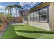 Artificial turf and tall palm trees create a peaceful ambiance in this cozy backyard at 11221 Stanwick Ave, Las Vegas, NV 89138