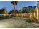 Beautiful backyard featuring artificial turf, a block wall, mature trees, and a paver patio at 11221 Stanwick Ave, Las Vegas, NV 89138