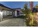 Paver patio and mature trees surrounding a home’s backyard creates a peaceful ambiance at dusk at 11221 Stanwick Ave, Las Vegas, NV 89138