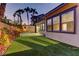 Artificial turf and tall palm trees create a peaceful ambiance in this cozy backyard at 11221 Stanwick Ave, Las Vegas, NV 89138