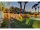 Beautiful backyard featuring artificial turf, a block wall, mature trees, and a paver patio at 11221 Stanwick Ave, Las Vegas, NV 89138