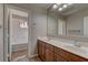 Bathroom featuring double sinks, a large mirror, and tiled floors at 11221 Stanwick Ave, Las Vegas, NV 89138