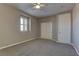 This bedroom features plush carpet, a ceiling fan, and a closet at 11221 Stanwick Ave, Las Vegas, NV 89138