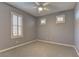Neutral bedroom with a ceiling fan, window shutters, and plush carpet at 11221 Stanwick Ave, Las Vegas, NV 89138