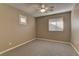 Standard bedroom with a ceiling fan, plush carpet, and natural light at 11221 Stanwick Ave, Las Vegas, NV 89138
