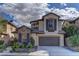 Charming two-story home with a stone-accented facade and a well-maintained front yard under cloudy skies at 11221 Stanwick Ave, Las Vegas, NV 89138