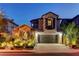 Charming two-story home with a stone-accented facade and a well-maintained front yard at twilight at 11221 Stanwick Ave, Las Vegas, NV 89138