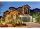 Charming two-story home with a stone-accented facade and a well-maintained front yard at twilight at 11221 Stanwick Ave, Las Vegas, NV 89138