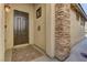 Inviting front entryway with a stone pillar, stylish door, and patterned welcome mat at 11221 Stanwick Ave, Las Vegas, NV 89138