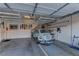 Spacious garage featuring overhead storage racks, skateboards, and a vintage turquoise car at 11221 Stanwick Ave, Las Vegas, NV 89138