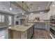 Open-concept kitchen featuring a large island with granite countertops and modern stainless steel appliances at 11221 Stanwick Ave, Las Vegas, NV 89138