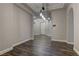 Open-concept living room featuring hardwood floors, elegant lighting, and neutral wall paint at 11221 Stanwick Ave, Las Vegas, NV 89138