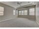 Spacious main bedroom featuring tray ceilings, plush carpet, and an abundance of natural light from multiple windows at 11221 Stanwick Ave, Las Vegas, NV 89138