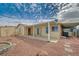 Backyard featuring an extended patio area with desert landscaping and a rock fire pit at 1292 Dalene Ave, Henderson, NV 89002