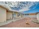 Desert-scaped backyard featuring an extended patio area, rock features, and block wall at 1292 Dalene Ave, Henderson, NV 89002