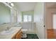 Bright bathroom featuring a large window over tub, toilet, and a spacious vanity with sink at 1292 Dalene Ave, Henderson, NV 89002