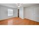 This bright bedroom has hardwood floors, a ceiling fan, and a closet for ample storage at 1292 Dalene Ave, Henderson, NV 89002