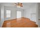 Bright bedroom featuring light walls, wood-look flooring, and a charming ceiling fan at 1292 Dalene Ave, Henderson, NV 89002