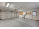 Spacious garage with painted floors, laundry area, utility sink, water heater, and overhead lighting at 1292 Dalene Ave, Henderson, NV 89002