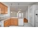 Bright kitchen with light wood cabinets, white appliances, and access to the living room at 1292 Dalene Ave, Henderson, NV 89002