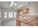 Bright kitchen with wood cabinets, breakfast bar, and view of the sunny dining area at 1292 Dalene Ave, Henderson, NV 89002