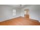 Living room with hardwood floors, ceiling fan, and arched entryway to the dining area at 1292 Dalene Ave, Henderson, NV 89002