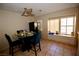 Cozy breakfast nook featuring a ceiling fan, large window, and a dining table set for a meal at 1505 Couples St, Las Vegas, NV 89128