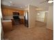 Open kitchen layout with stainless steel appliances, wood cabinets, and a view of the upstairs loft area at 1505 Couples St, Las Vegas, NV 89128