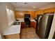 Charming kitchen with stainless steel appliances, wood cabinets, and tile flooring under recessed lighting at 1505 Couples St, Las Vegas, NV 89128