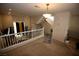 Bright loft space featuring carpet flooring, staircase, railing and natural light streaming through the windows at 1505 Couples St, Las Vegas, NV 89128