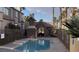 Inviting community pool area featuring a stone cabana and lush palm trees at 1505 Couples St, Las Vegas, NV 89128