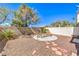 Backyard patio area featuring mature landscaping and a rock garden at 1634 Clint Canyon Dr, Henderson, NV 89002