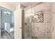 Bathroom featuring marble tile shower with glass door and chevron accent at 1634 Clint Canyon Dr, Henderson, NV 89002
