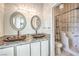 Bathroom featuring double sinks with stone countertops, and a bathtub/shower combo with a handicap accessible door at 1634 Clint Canyon Dr, Henderson, NV 89002