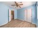 Bedroom featuring vinyl floors, blue walls, a ceiling fan, closet and a doorway at 1634 Clint Canyon Dr, Henderson, NV 89002