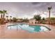 Community pool surrounded by palm trees, offering a relaxing recreational space at 1634 Clint Canyon Dr, Henderson, NV 89002