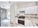 Kitchen with stainless steel oven, granite counters, and white cabinets at 1634 Clint Canyon Dr, Henderson, NV 89002