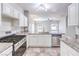 Bright kitchen features stainless steel appliances, granite counters, and white cabinets at 1634 Clint Canyon Dr, Henderson, NV 89002