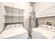 Functional laundry room with shelving and modern appliances at 1634 Clint Canyon Dr, Henderson, NV 89002