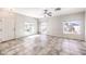 Open living room features tile flooring, large windows, and a ceiling fan at 1634 Clint Canyon Dr, Henderson, NV 89002