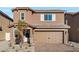 Charming two-story home with brick driveway, two-car garage, and a well-manicured front yard at 1704 Desert Path Ave, North Las Vegas, NV 89032